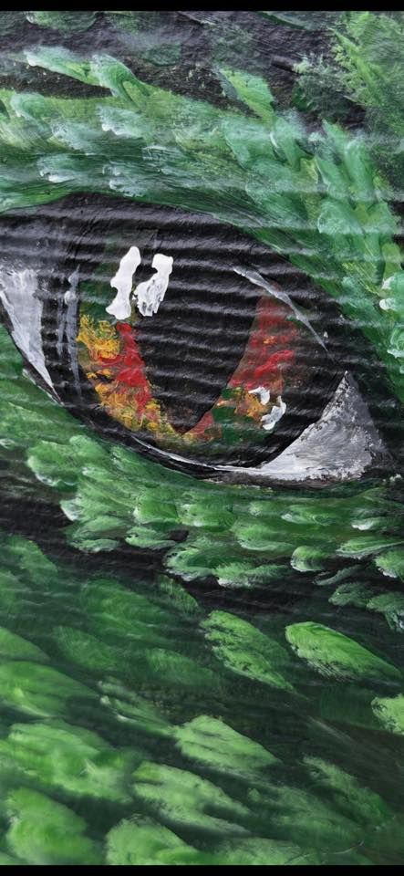 Extreme close up of the dragon's red and gold eye